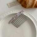 Detail of purple marble acetate hair comb with metal teeth on a white plate - Purple Marble