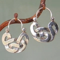 Vintage silver knot woven earrings with ethnic geometry hanging on a branch display - Woven Knot