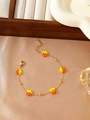 Detail of yellow and orange floral beaded bracelet with adjustable gold chain on silk - Orange and Yellow