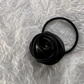 Close-up of a premium black satin rose hair tie on a white textured background - Small / Black