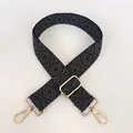 Close-up of gray geometric jacquard weave strap with polished gold metal swivel hooks - Grey + Gold Hook