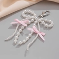 Detail of handmade pearl bow keychain with pink ribbons and silver lobster clasp on satin - Double Bow Pearl Tassel