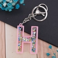 Pink resin alphabet letter H keychain with colorful star sequins and silver ring - Letter H