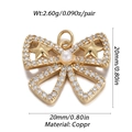 Macro detail of a gold copper bow pendant with white zircon and a central pearl accent - Pearl & Pave Bow (YSN008-05)