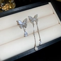 Detail of asymmetric butterfly earrings with butterfly wings, pearls and zircon tassels - Asymmetrical Butterfly Tassel Style / Silver
