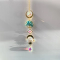 Golden Tree of Life crystal suncatcher with moon prism reflecting rainbow light on wall - Synthetic Turquoise Tree of Life