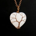 Detailed view of handmade bronze wire-wrapped tree of life on heart opal pendant - Antique Copper + Clear Quartz