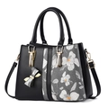 Elegant black faux leather tote with floral print and gold hardware for women - Black