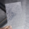 Macro detail of F-9 nail art stencil template with rainbow and arc patterns - Stacked Semicircle Style (F-9)