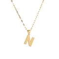 Macro detail of gold letter N pendant featuring unique dotted texture on a fine chain - Letter N