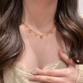 Elegant gold heart pendant necklace with shimmering jade-like stones on a model - Gold Heart Necklace (Adjustable)