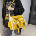 Yellow and off-white canvas messenger bag with functional pockets and a green charm - Random Badges + Dinosaur Pendant / Yellow & White