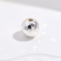 Macro shot of 925 sterling silver beads with laser hammered texture and honeycomb finish - Silver 6mm Honeycomb Bead