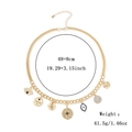 Goldfarbene Bib-Halskette mit mystischen Münzanhängern und Charms auf weißem Hintergrund - Böser Blick Sonne Halskette / Gold