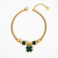 Elegant gold clover bracelet with sparkling green crystals and a dainty beaded chain - Gold + Green Zirconia
