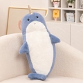Plush narwhal toy in grey-blue and white with a golden horn on a cozy sofa - Narwhal / 70cm