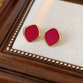 Macro shot of red flocked square earrings with gold metal frame on a wooden tray - 925 Silver Earring Post / Gold Red Rhombus