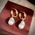 Orecchini a cerchio dorati con perle irregolari su sfondo di carta vintage variante SKU - Oro (Perno per orecchini in argento sterling 925)