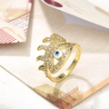 Macro shot of gold-plated evil eye ring with blue stone and cubic zirconia inlay - Mixed Color Eye