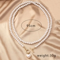 Detail view of 95cm double-layer pearl necklace with heart pendant and OT buckle on silk - Pearl Necklace (X296)