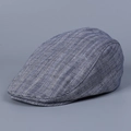 Close-up of blue and white herringbone fabric detail on a retro British flat cap - Navy Blue