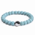 Detailed view of blue turquoise beads with Yin Yang charm on an elastic cord bracelet - Blue Turquoise (Tai Chi Pendant)