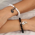 Detail of couple friendship bracelets with black and white beads and Yin Yang pendants - Black and White Yin Yang Set