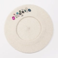 Detailed texture of beige wool beret featuring multi-colored rhinestones and gems - One Size / Beige