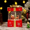 Red Christmas gift box snow globe featuring Santa in a sleigh with LED warm lighting - Large Red Gift Box Santa Claus