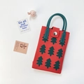 Macro shot of red knit tote bag with festive green Christmas tree pattern detail - Xmas Tree Red
