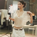 Detail shot of a beige V-neck knitted top with short sleeves in a soft lifestyle setting - S / T-Shirts / Apricot