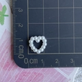 Detailed view of a white heart-shaped faux pearl bead showing exact 1cm size on scale - Heart