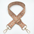 Macro detail of geometric jacquard shoulder strap with golden metal lobster clasps - Orange