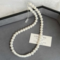 Detail of pearl necklace with matte silver tube on a luxury grey velvet jewelry tray - 9# Silver Curved Tube Pearl Style