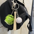 Three-piece baseball keychain with green glove, wooden bat, and white ball on a black bag - 2CM White Ball Long Bat Green Glove