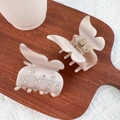 Pink butterfly acetate hair claw clips with rhinestones shown on a wooden tray - Beige Butterfly 7CM