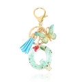 Green resin letter Q keychain with dried flowers, blue tassel and butterfly pendant - Letter Q
