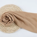 Light brown chiffon hijab scarf with fine stitching on natural straw mat background - 86