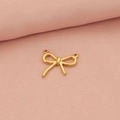 Golden bow-shaped stainless steel pendant displayed on a soft pink fabric background - Gold Bow 2 Pendant