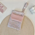 Detailed view of floral pink nurse pocket organizer with snap button strap and grid flap - Twill Flowers