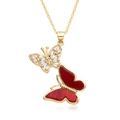 Macro detail of gold double butterfly pendant with red inlay and micro-pave crystals - Red Butterfly Style (F249)