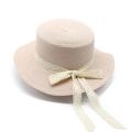 Detailed view of breathable woven straw hat with delicate white lace bow and wavy brim - M (56-58cm) / Pink