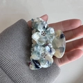 Detail of floral acetate hair claw with blue marble texture and rhinestone accents - 7cm / Light Green Floral