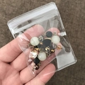 Clear PVC zip lock jewelry bag containing white and black beads with golden DIY components - 100 Pieces / 6*8cm (26 Microns)