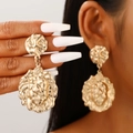 Exaggerated golden lion head earrings with textured metallic finish worn by model - Lion Head Relief Shiny Gold (N-825)