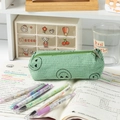 Mint green corduroy pencil case with embroidered smiley face on a study desk - Green Heart-Eye Pencil Case