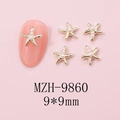 Detailed macro view of 9mm gold starfish nail art charms with pearls on pink background - MZH-9860 (9*9mm)