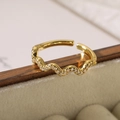Macro shot of 18K gold plated irregular wave ring with zircon stones on beige velvet - 13849-Simple Gold Wave Rhinestone