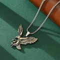 Close-up of a vintage bronze eagle pendant on a silver metal chain with detailed feathers - Vintage Gold Eagle Pendant