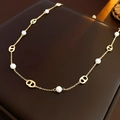 Detailed view of gold plated pig nose chain necklace with white pearls on jewelry box - Gold Pig Nose Style (95#)